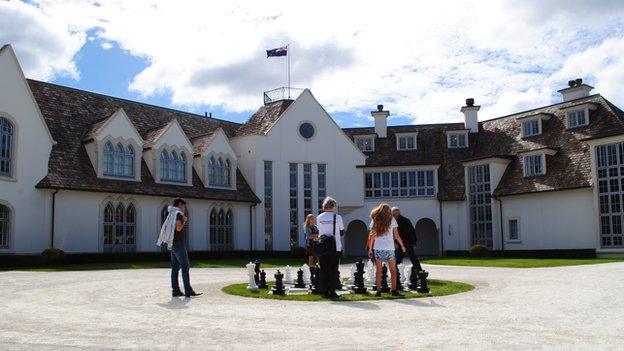 Dotcom Mansion with people playing chess outside