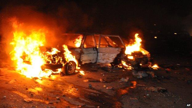 Car burns following a bomb blast in Abuja on 1 May 2014