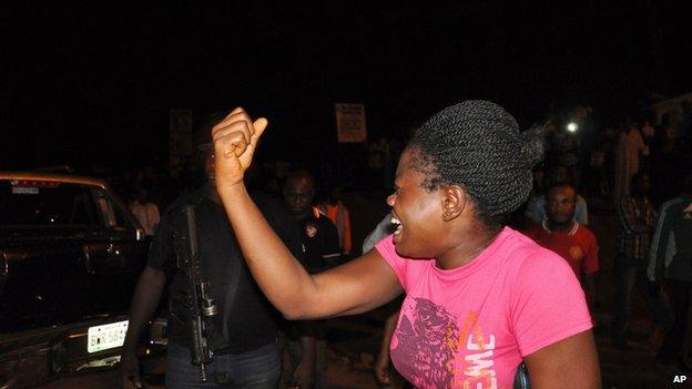 Woman reacts at the scene of the bombing in Abuja on 1 May 2014