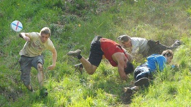 Cheese-rolling racers tumble down Cooper's Hill