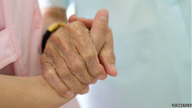 carer holding old person's hand