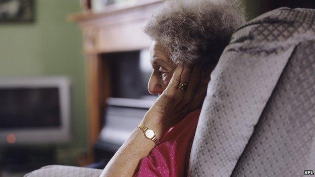 Elderly woman sitting alone