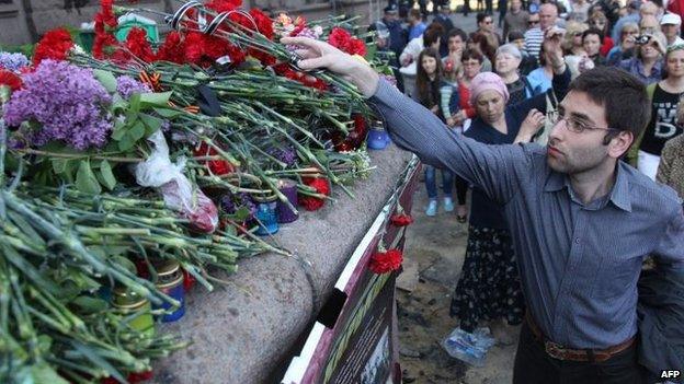 Flowers are left at the burned building in Odessa, 3 May