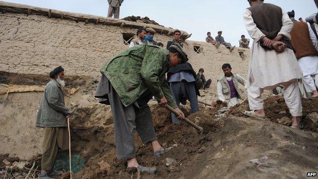 Rescuers in Ab Barak village on 3 May 2014