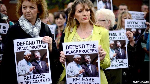 People holding "release Gerry Adams" posters