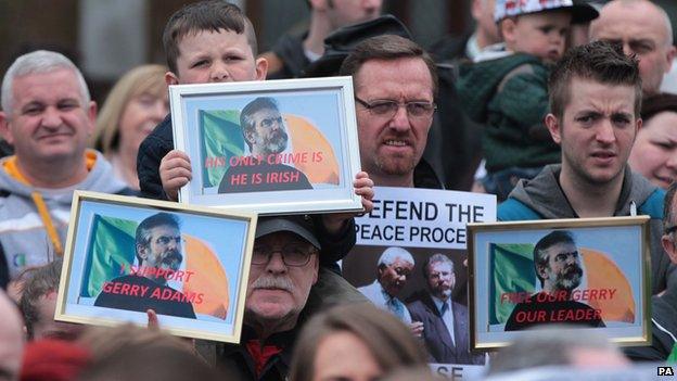 People holding "release Gerry Adams" posters