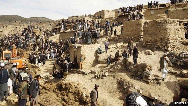 Afghan villagers gather at the site of a landslide at the Argo district in Badakhshan province, - 3 May 2014