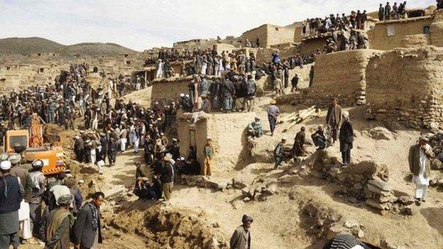 Afghan villagers gather at the site of a landslide at the Argo district in Badakhshan province, - 3 May 2014