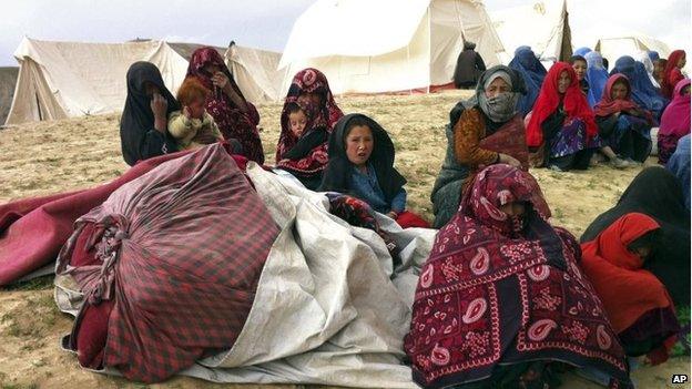 Survivors sit with their possessions near the site of Friday's landslide that buried Ab Barik village in Badakhshan province, north-eastern Afghanistan, 3 May 2014