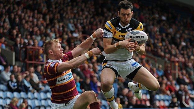 Castleford winger Kirk Dixon catches the ball under pressure from Huddersfield opposite number Aaron Murphy