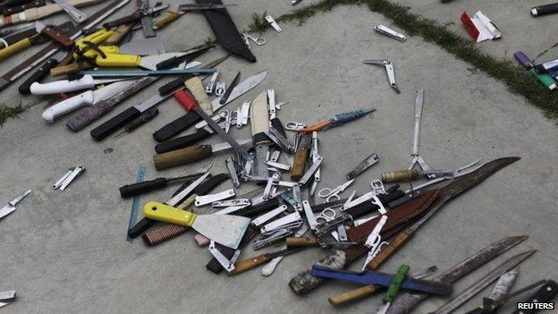 Bladed weapons lie on the ground outside the maximum security prison in Tamara on the outskirts of Tegucigalpa on 25 February, 2014