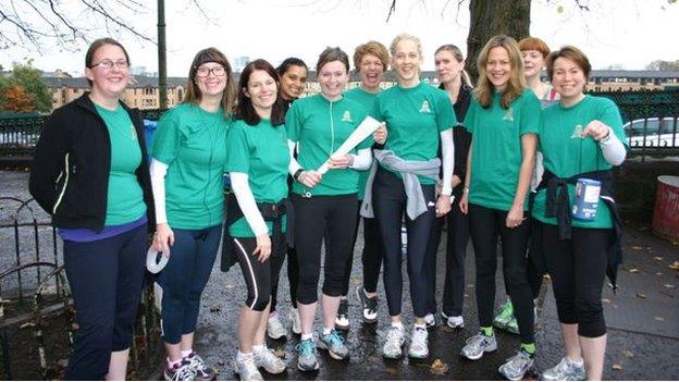 Louise Love (holding a baton) with her running group