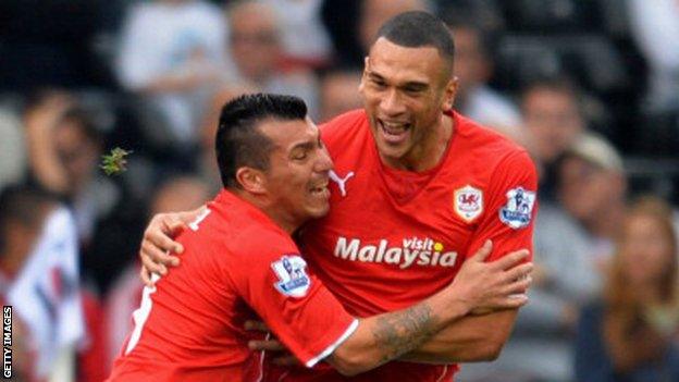 Gary Medel and Steve Caulker celebrate a Cardiff goal