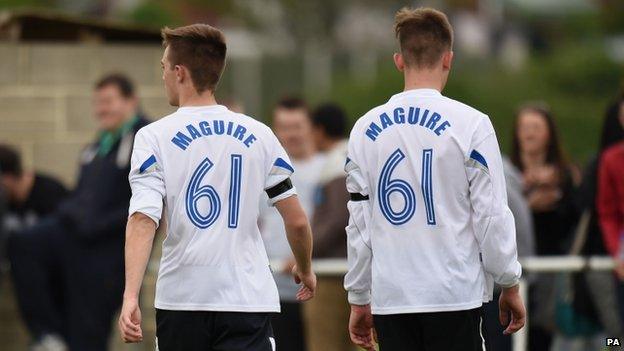 Two players in "Maguire" shirts