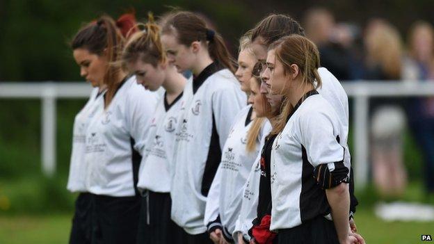 Players take part in a one-minute silence