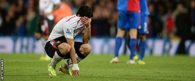 Suarez is dejected as Liverpool's title chances take a major hit