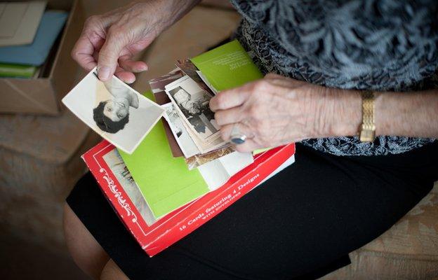 Elaine sorts through old photographs