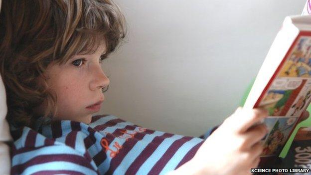 A young child reading a book