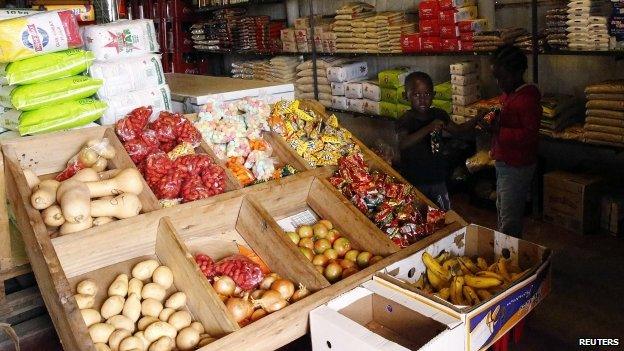 Children stand inside a shop in Nkaneng township