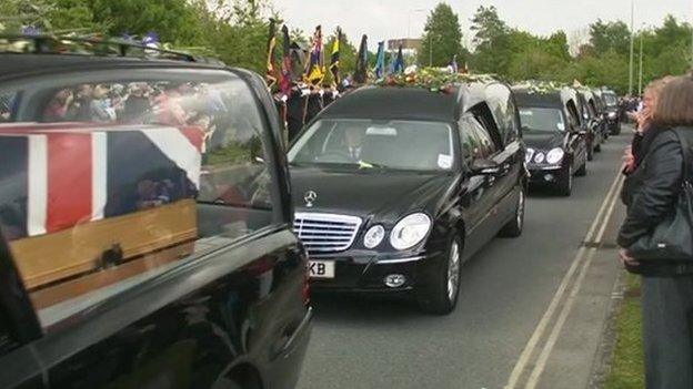 the cortege makes its way out of RAF Brize Norton