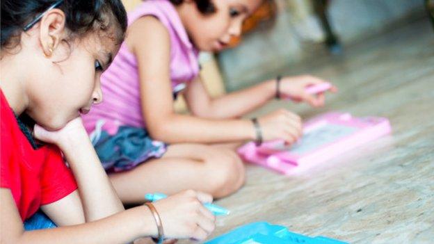 children looking at whiteboards