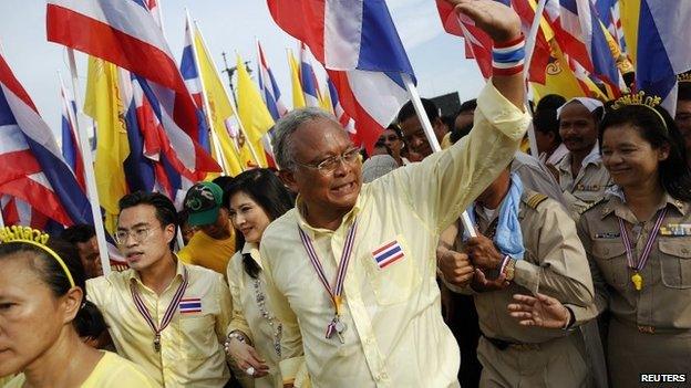 Anti-government protest leader Suthep Thaugsuban waves to his supporters as he marches near the Grand Palace on Coronation Day in Bangkok on 5 May 2014