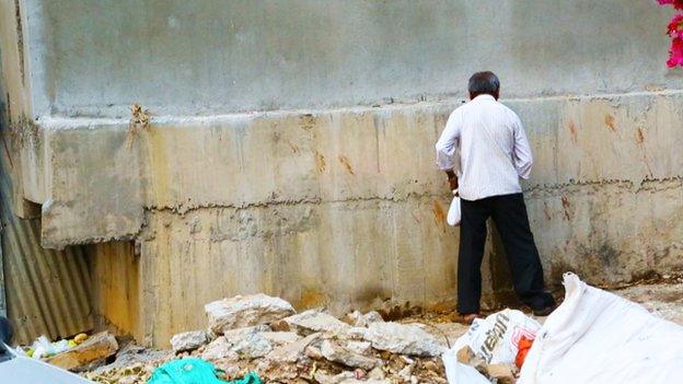 A man urinating on the street in Bangalore