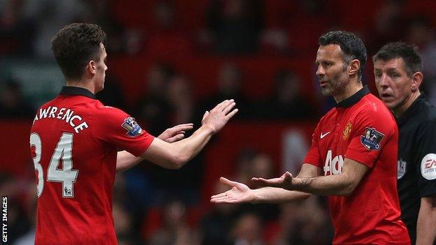 Tom Lawrence greets Ryan Giggs as he is replaced following his first team debut for Manchester United