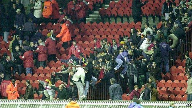 Paris Saint-Germain supporters fight with supporters of Turkish team Galatasaray in the stands at the Parc des Princes stadium in Paris on 13 March, 2001