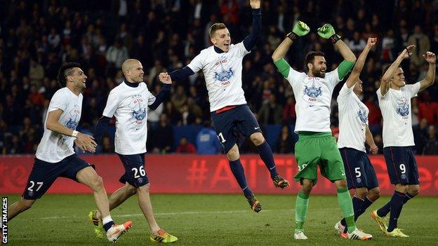 Paris St-Germain players take the acclaim of their supporters after winning their second straight Ligue 1 title