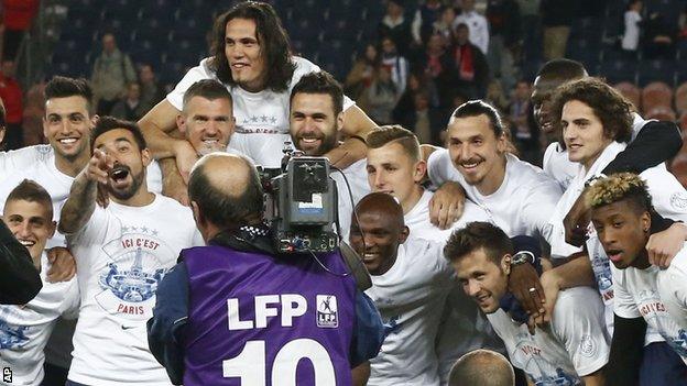 Paris St-Germain players take the acclaim of their supporters after winning their second straight Ligue 1 title