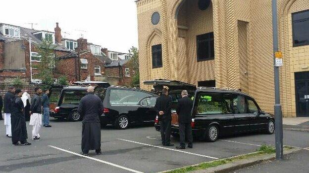 Hearses outside mosque