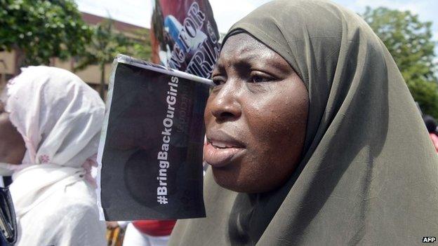 A woman chants slogans alongside members of Lagos based civil society groups holding a rally calling for the release of missing Chibok school girls at the state government house, in Lagos, Nigeria, on 5 May 2014