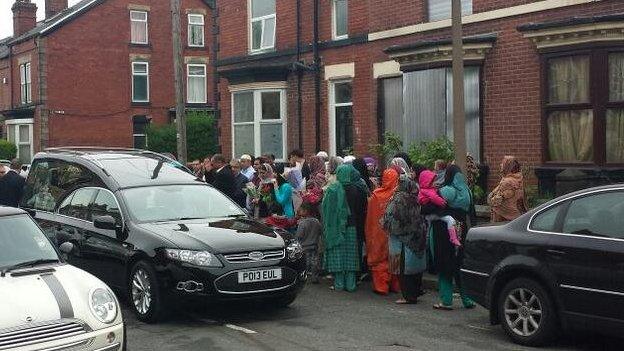 People paying respects as the funeral cortege passes