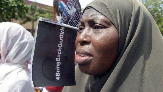 A woman chants slogans alongside members of Lagos based civil society groups holding a rally calling for the release of missing Chibok school girls at the state government house, in Lagos, Nigeria, on 5 May 2014