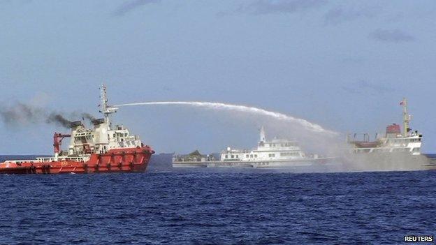 A Chinese ship (left) uses water cannon on a Vietnamese Sea Guard ship on the South China Sea on 3 May 2014