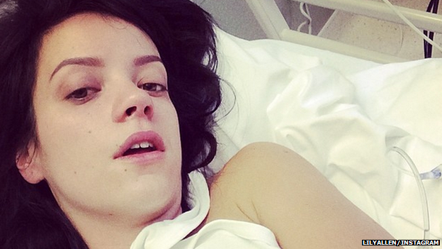 Lily Allen in a hospital bed with a drip