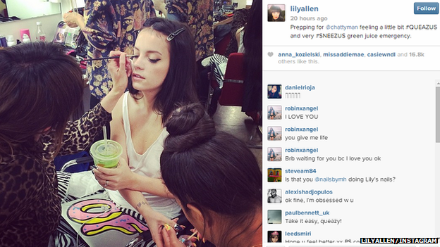 Lily Allen getting her make-up done while holding a green drink