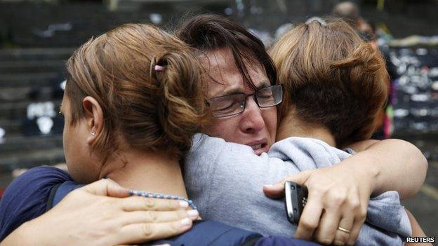 A woman cries at an anti-government protesters' camp site dismantled by Venezuela's national guard in Caracas on 8 May, 2014