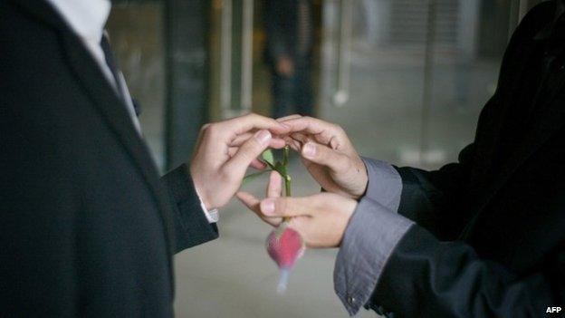 A gay couple exchange rings during their ceremonial "wedding" as they try to raise awareness of the issue of homosexual marriage in central China's Hubei province (March 2011)