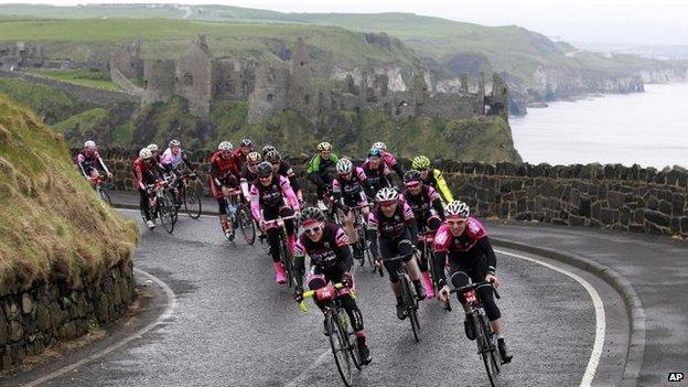 Cyclists pass Dunluce Castle