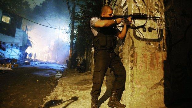 Brazilian police patrol following shootings in the pacified Pavao-Pavaozinho community, just blocks from Copacabana Beach, on April 22, 2014