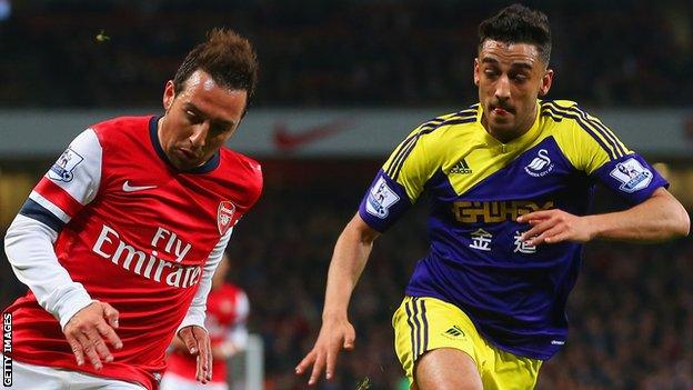 Santi Cazorla of Arsenal and Neil Taylor of Swansea City