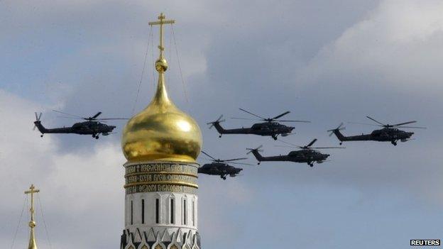 Military helicopters fly in formation during rehearsals for the Victory Day military parade