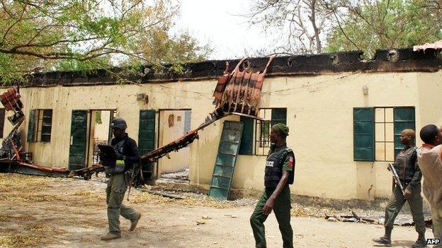 Police officers walk past the Chibok school where the schoolgirls were abducted - 21 April 2014