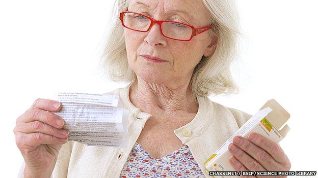 Woman reading patient information for her medicine