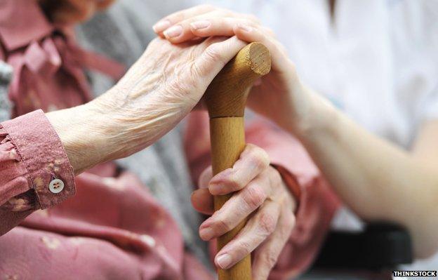 Elderly woman and young woman's hands