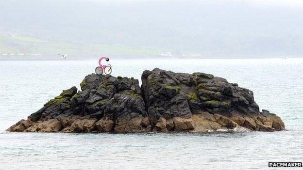 Pink bicycle model on a rock