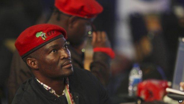 Members of the newly formed Economic Freedom Fighter's (EFF) party monitor early results of South African elections at the Independent Electoral Commission Results Center, in Pretoria, South Africa, 8 May 2014