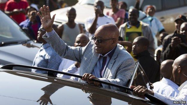 South African President Jacob Zuma greets supporters of African National Congress after voting at a voting station in the Nkandla district, 7 May 2014